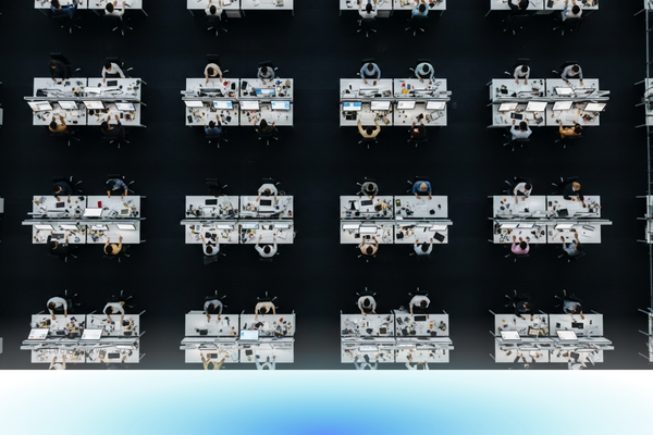 Abstract office-blue gradient suggesting enterprise-scale software adoption hitting daily-use threshold.